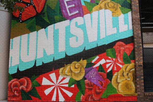 Mural with colorful flowers and the word Huntsville in the center in blue and white