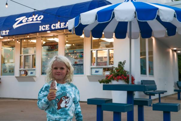 A girl eating ice cream in front of Zesto Ice Cream parlor in steuben county,