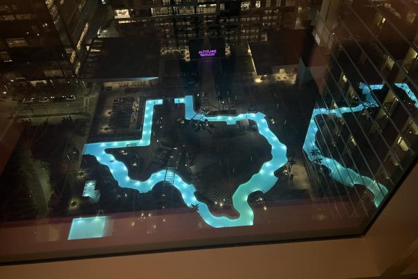 lazy river shaped like Texas lit up in blue at night