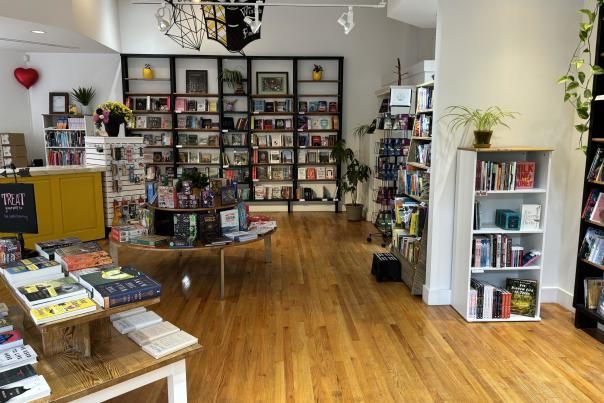Bookstore layout showing books on shelves and tables.