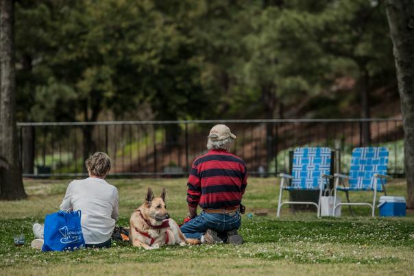 Family and dog enjoying a picnic