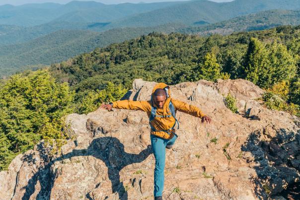 Man hops the rocks atop Old Rag Mountain