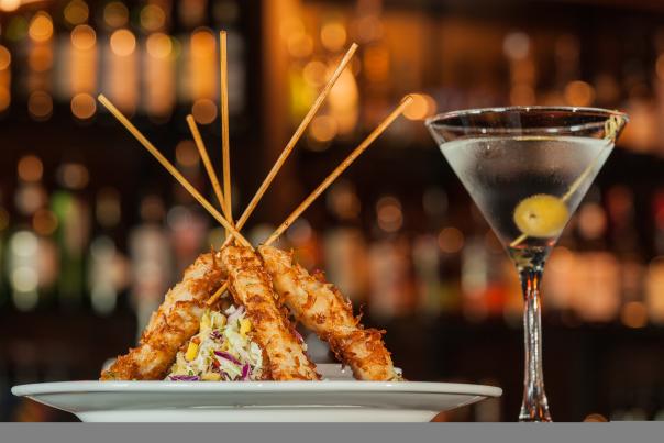 Cocktail and chicken skewers on a plate