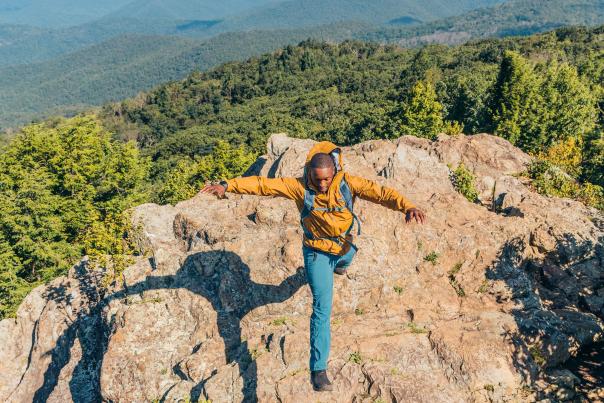 Man hops the rocks atop Old Rag Mountain
