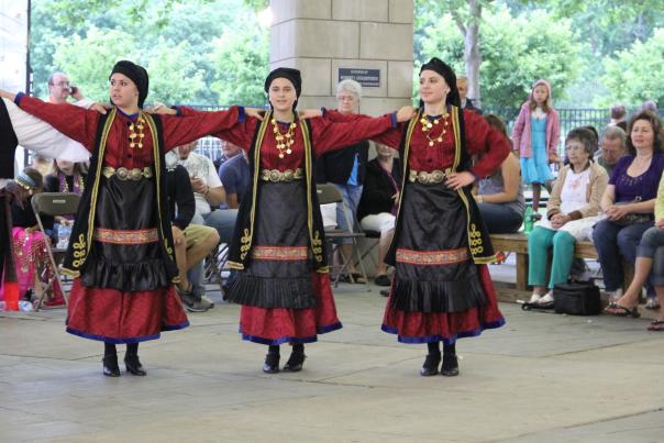 Three women dancing in greek costumes