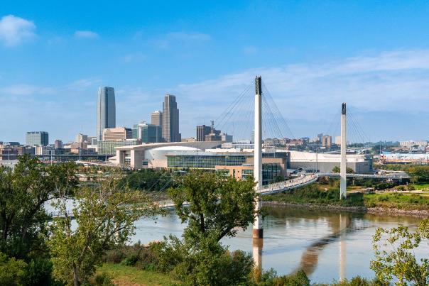 The skyline of Omaha showing skyscrapers, convention center and Bob the Bridge over the Missouri River.