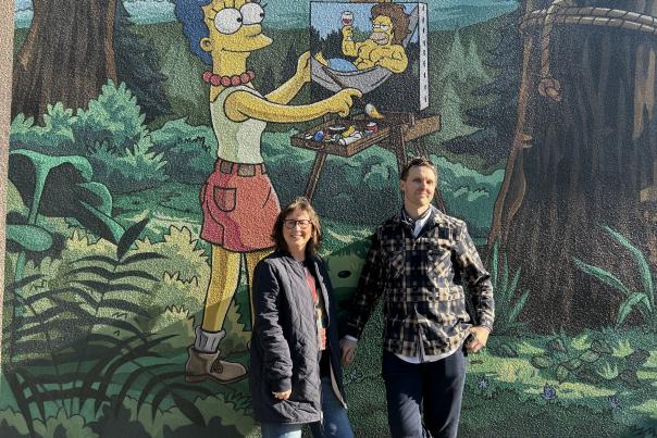 The author and husband in front of the official Simpsons mural in Springfield, OR.