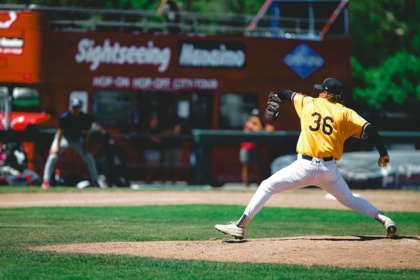 A baseballer getting ready to throw the ball.