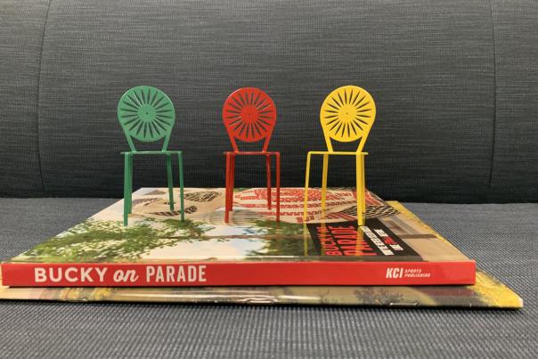 3 mini terrace chairs sit on top of a book