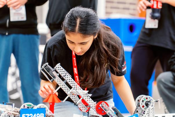 a teenage girl building robotics