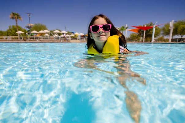 Girl wearing sunglasses in a swimming pool