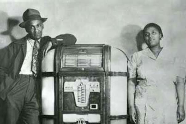 Lola West and an unidentified man stand by a jukebox at the Black and Tan in Cheyenne, Wyoming