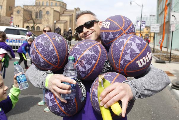 Volunteer holding basketballs