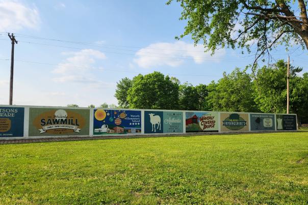 The Historic Mural Wall at Old Town Waverly Park features old fashioned advertisement style murals detailing actual businesses that existed in Morgan County at one time.