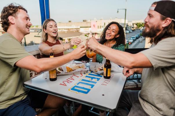 Two couples cheers their tacos at Blind Salamander Cantina in Downtown San Marcos