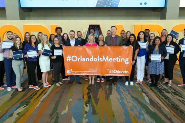 Visit Orlando employees pose with Ray Walls, Deputy Director, OCCC, Casandra Matej and David Ingram, General Manager, OCCC at GMID