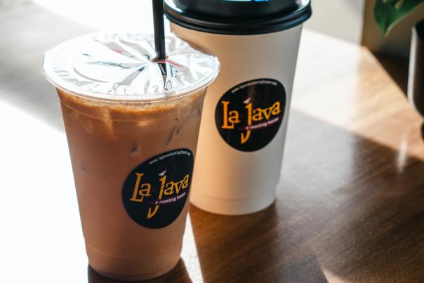 Two cups of LaJava coffee sitting on a table.