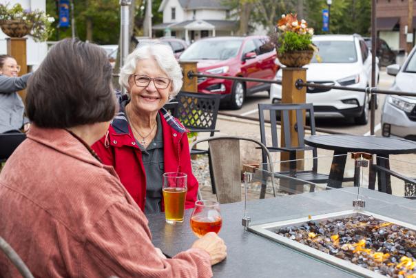 Two ladies drinking on the Looking Glass Brewing Company patio