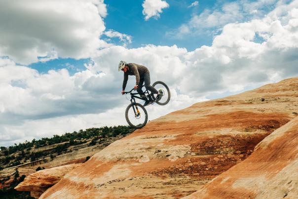 Mountain Biker Going Down a Rock Slab in Lunch Loops