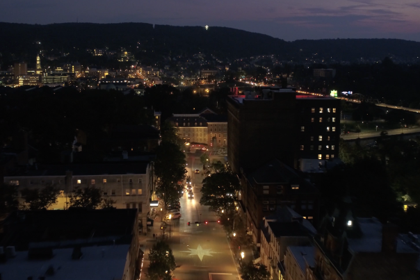 An aerial view of Main Street Bethlehem at night, facing South Mountain with the Star of Bethlehem lit up