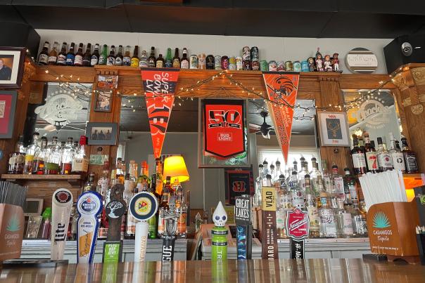 Image is of the bar at Coaches Corner and you can see what is on draft including Miller, Rhinegeist, Madtree and others.