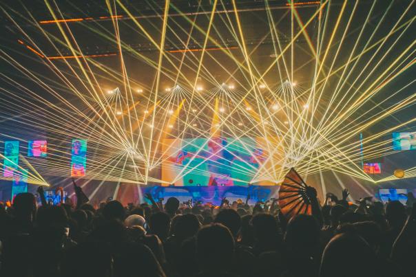 Lights and lasers over a crowd at an electronic music concert