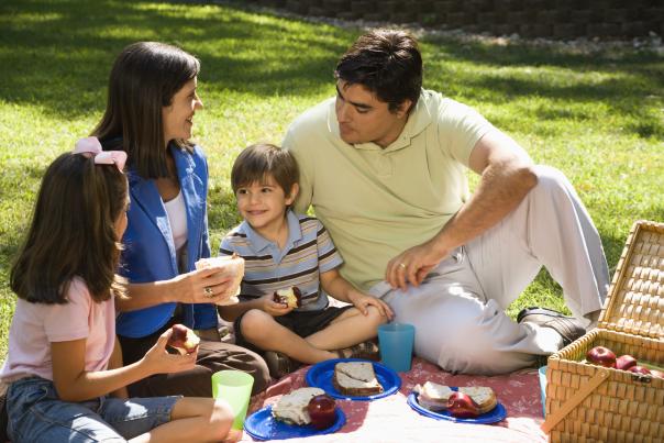 A hispanic family enjoying a picnic