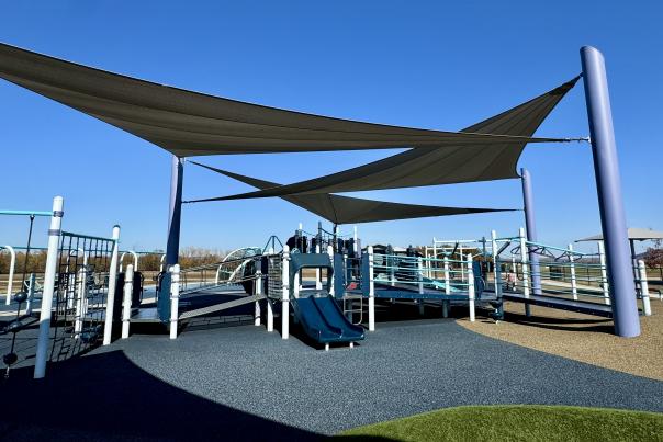 Cabanas shade the play equipment on a sunny day with perfectly clear skies at John Bell Jr. Park in Fort Smith, Arkansas.