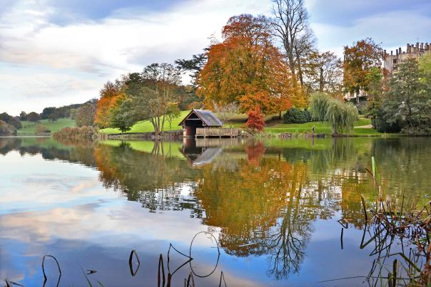 Sherborne Castle lake and boathouse in autumn