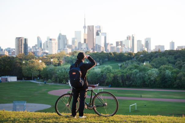 A person looks at the Toronto skyline from Riverdale Park in Toronto's east end
