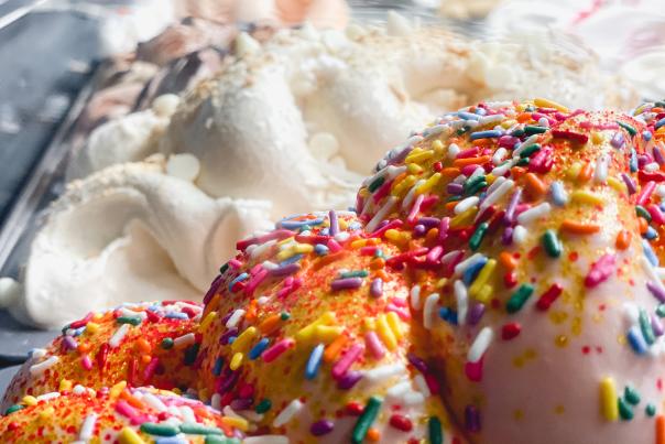 Close up image inside a case of gelato covered in sprinkles