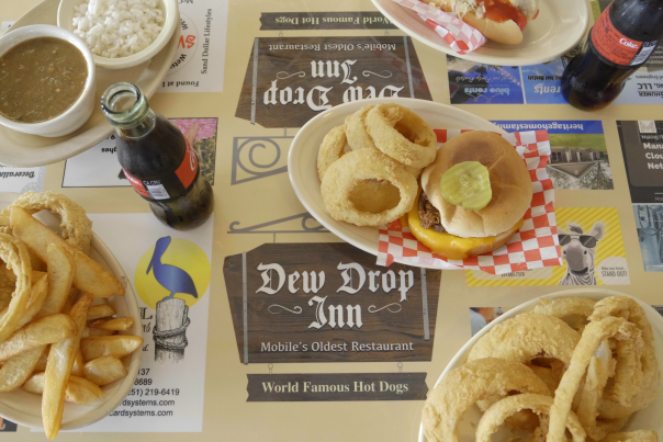plates of food with cheeseburger and onion rings