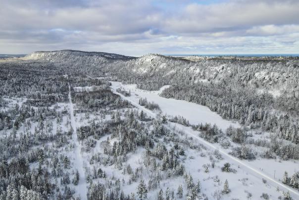 Winter Aerial with Trees, Trails, and Mountains