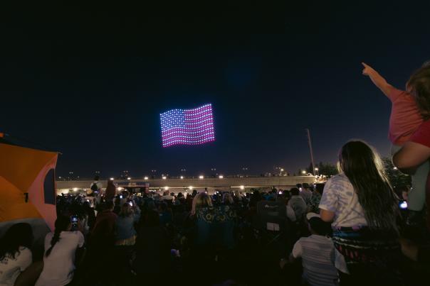 Stock footage of an American flag illuminated by drones during a drone show.
