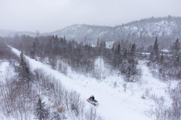 a snowmobiler looking over a wintery landscape