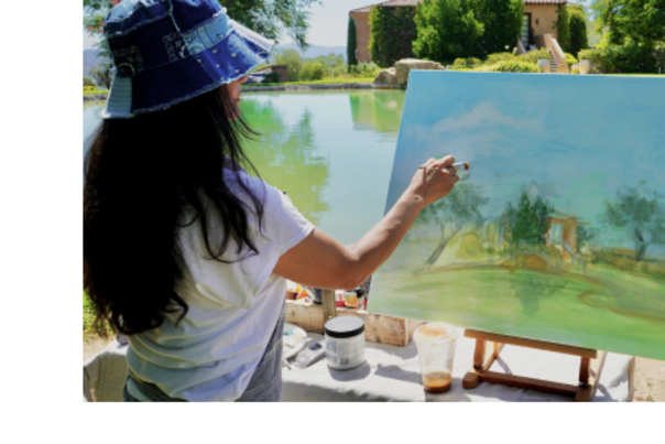 Artist in front of a canvas, painting a colorful landscape of Temecula.