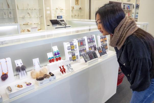 An Alaska Native woman browses a display of Alaska Native–made jewelry in an Anchorage gift shop.