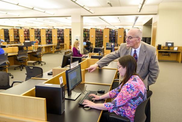 Woman and man on a computer at the Genealogy Center at the Allen County Public Library. The man is pointing to something on the computer screen.