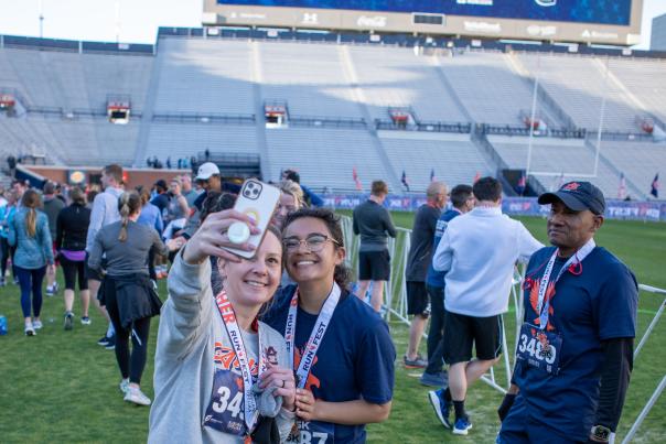 Two young women stop for a selfie after completing the War Eagle Run Fest.