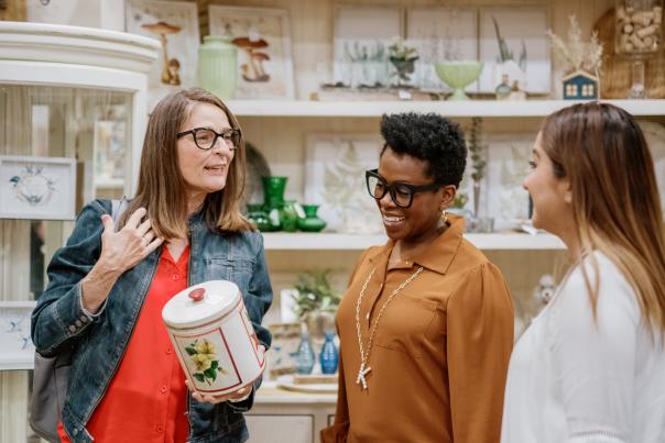 women looking at a canister in a store