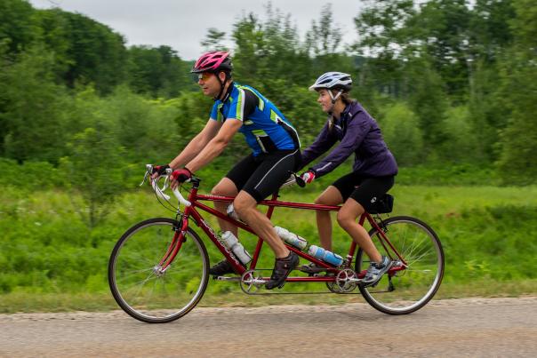 2 riders on a tandem bicycle in Grayling