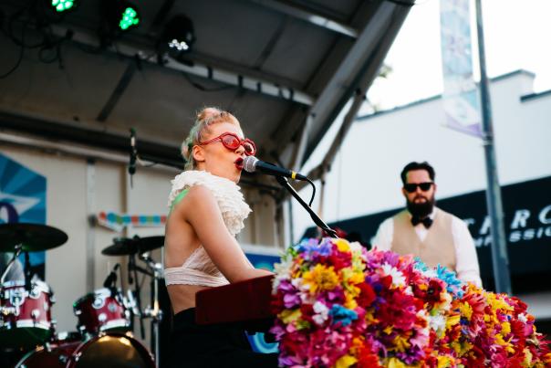 Woman with red sunglasses singing at AthFest