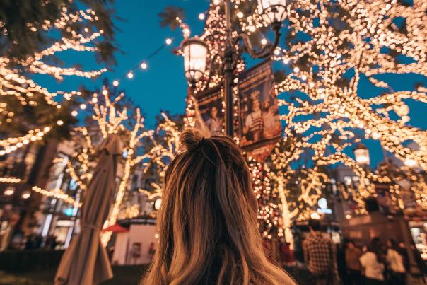 A woman stares up at seasonal lights in Las Angeles