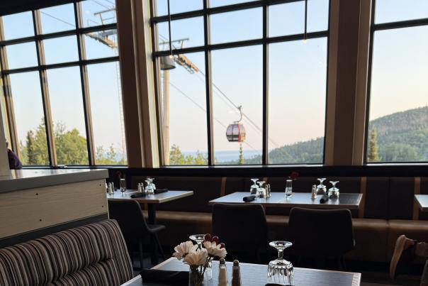 Photo of a dining room with large windows that frame a gondola outside