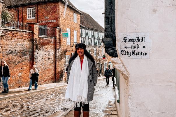 A woman posing for a photo on Steep Hill.
