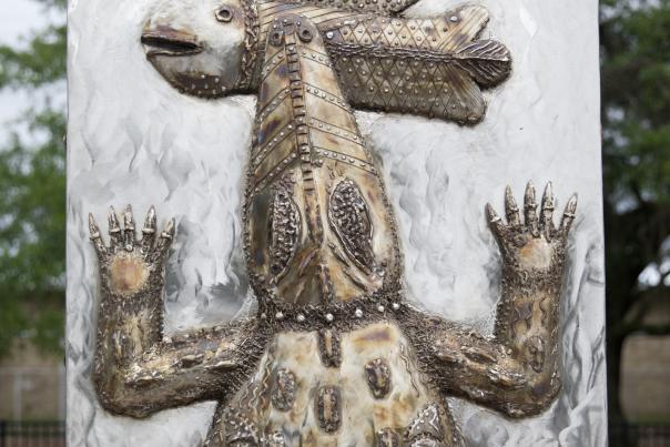 rectangular steel sculpture with an alligator