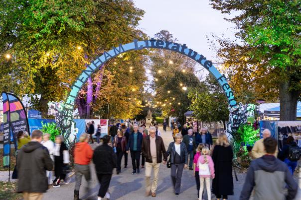 Cheltenham Literature Festival 2025 attendees walking under famous blue arch
