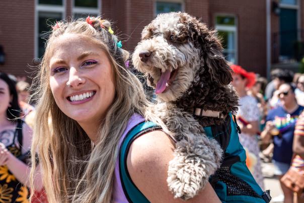Person with a dog at Pride Festival