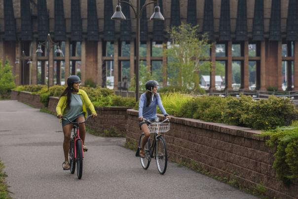 Two bikers riding down the Marquette city path near Lower Harbor in Marquette