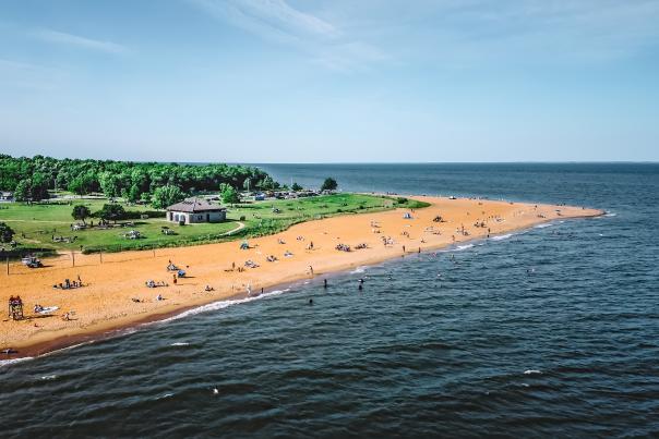 An aerial shot of a beach with water in the background
